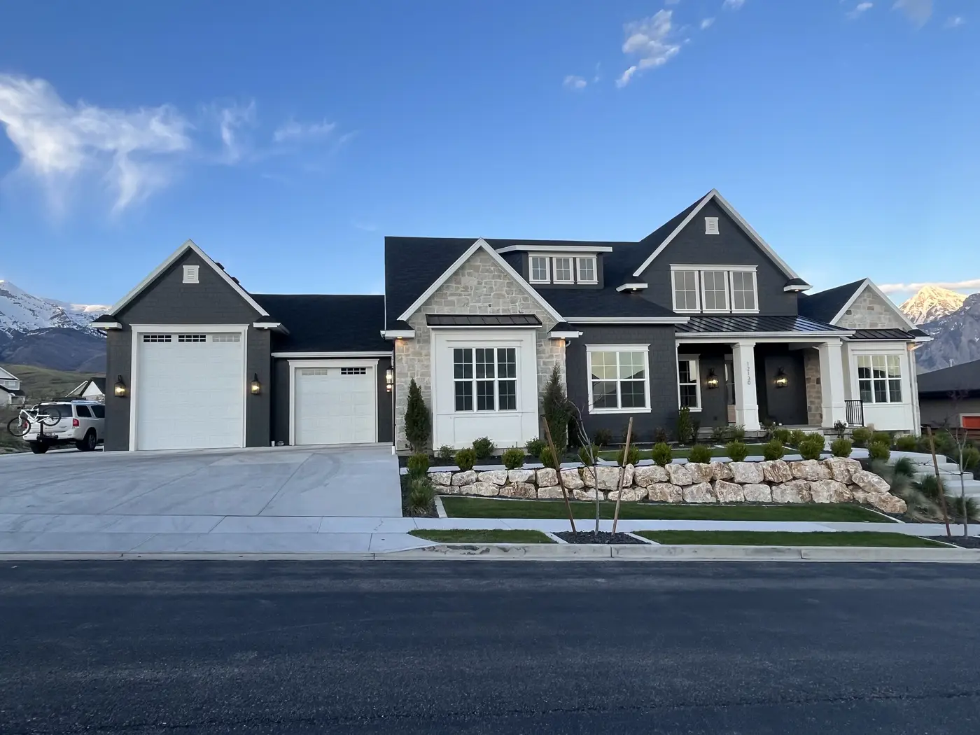 Custom home in Highland, Utah -- stone, black metal, timber beams with Wasatch Range
